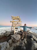 Alex on the summit of Mount Kilimanjaro