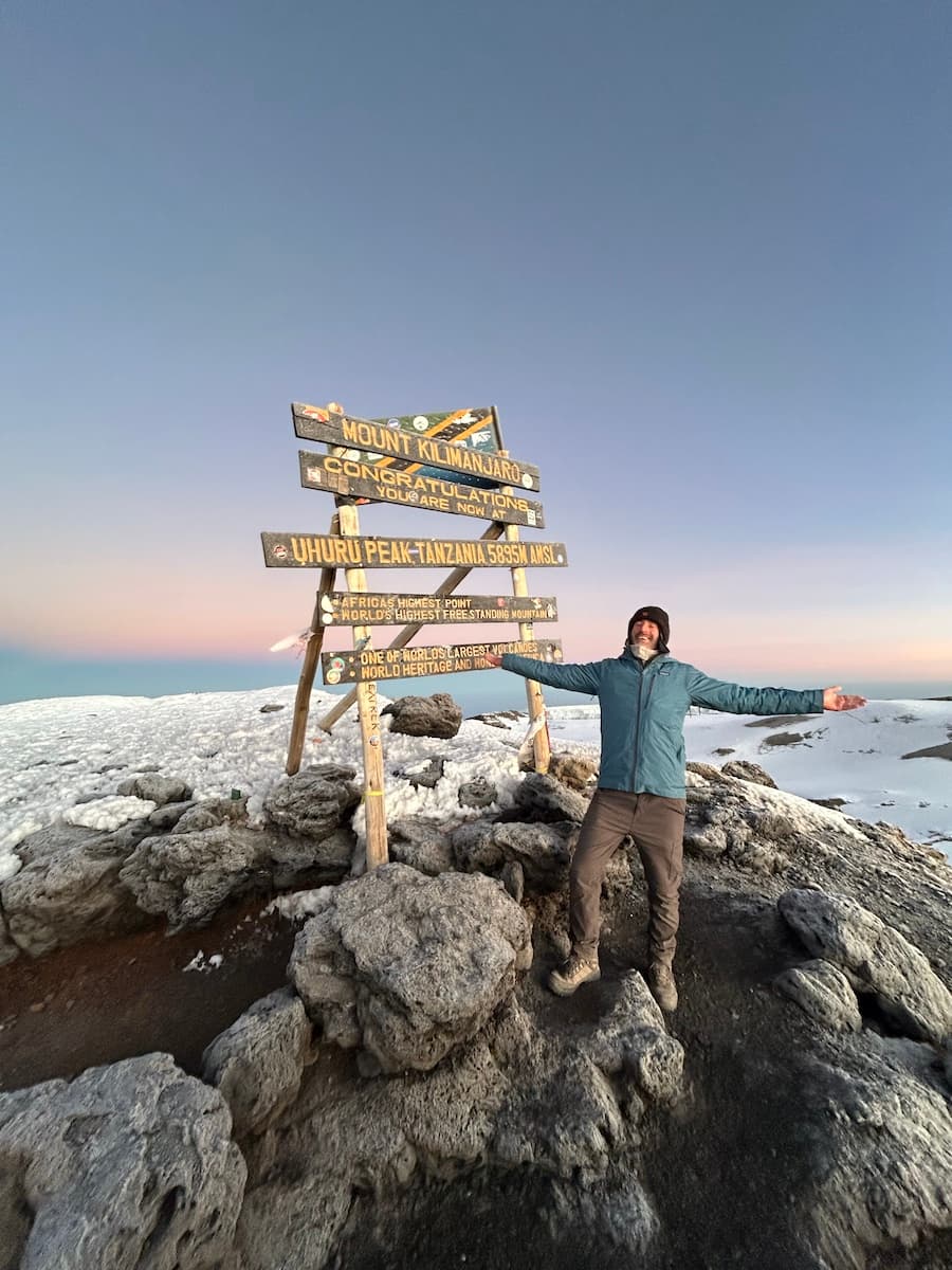 Alex on the summit of Mount Kilimanjaro